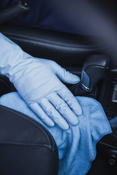 Cropped view of car cleaner wiping gear shifter with rag — Stock Photo