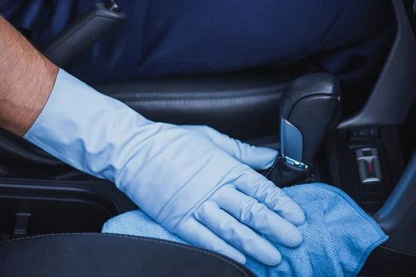 Cropped view of car cleaner wiping gear shifter with rag — Stock Photo
