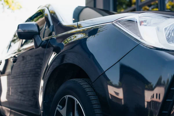 Frontal y lateral de negro, coche moderno pulido - foto de stock