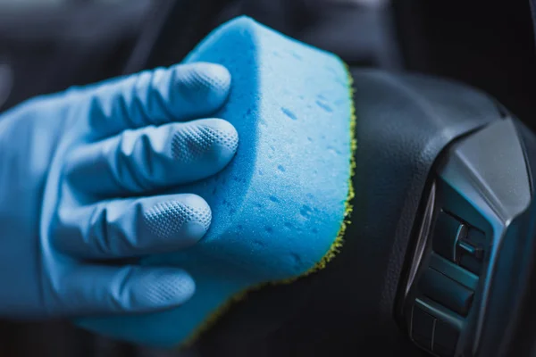 Cropped view of car cleaner wiping car with sponge — Stock Photo