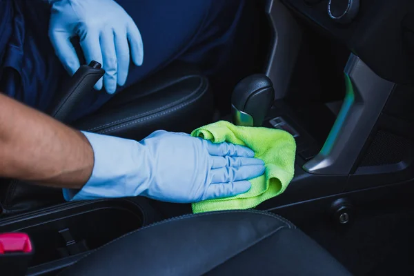 Partial view of car cleaner wiping gear shifter with rag — Stock Photo