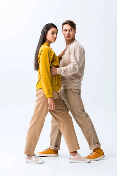 Handsome man standing with stylish girl on white — Stock Photo