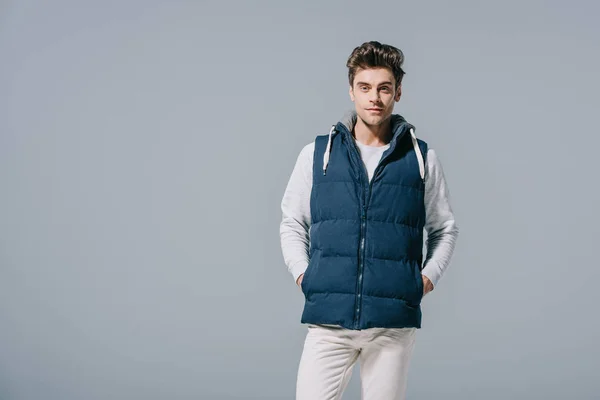 Handsome caucasian man posing in waistcoat, isolated on grey — Stock Photo