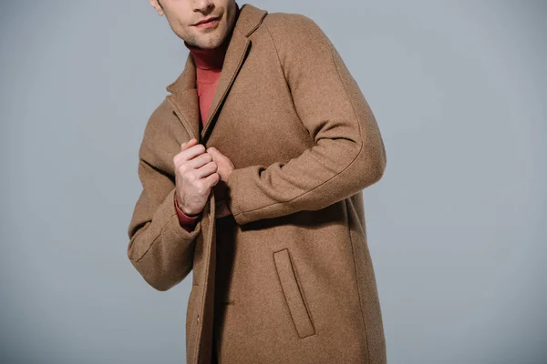 Cropped view of fashionable man posing in beige coat, isolated on grey — Stock Photo