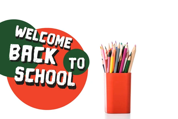 Pen holder with multicolored pencils near welcome back to school letters on white — Stock Photo