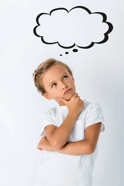 Pensive kid touching face near blank thought bubble on white — Stock Photo