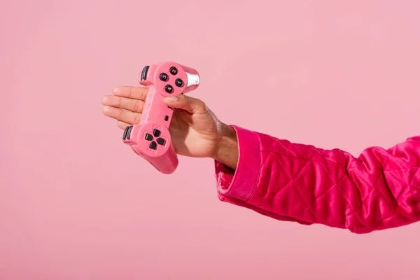KYIV, UKRAINE - SEPTEMBER 16, 2019: cropped view of african american woman holding joystick isolated on pink, fashion doll concept — Stock Photo