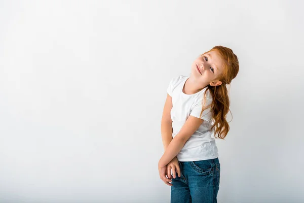 Happy redhead kid looking at camera on white — Stock Photo