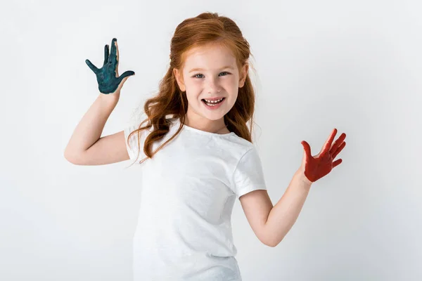 Cheerful redhead kid with paint on hands standing isolated on white — Stock Photo