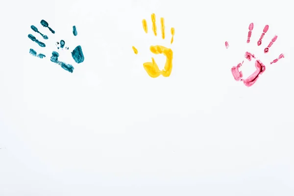 Blue, yellow and red hand prints on white — Stock Photo
