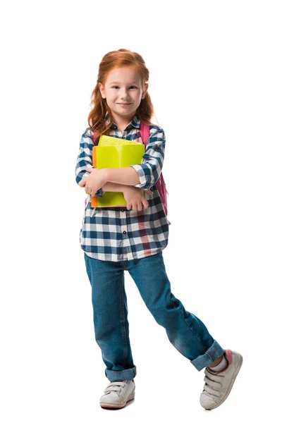 Happy kid in denim jeans holding books isolated on white — Stock Photo