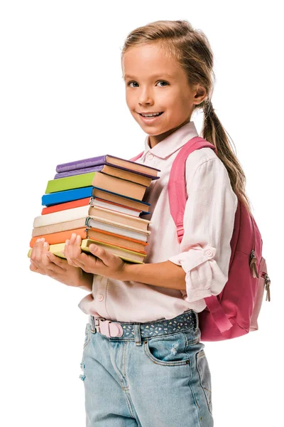 Sonriente colegial sosteniendo coloridos libros aislados en blanco - foto de stock