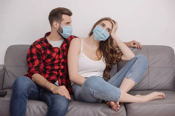 Young man looking at depressed girl looking away and touching head — Stock Photo