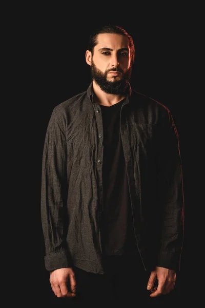 Bearded muslim man looking at camera isolated on black — Stock Photo