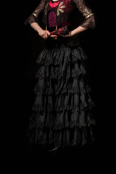 Cropped view of flamenco dancer holding fan isolated on black — Stock Photo