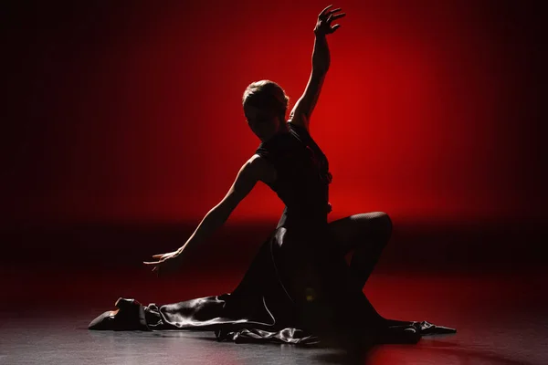 Silhouette di donna elegante che balla il flamenco sul rosso — Foto stock