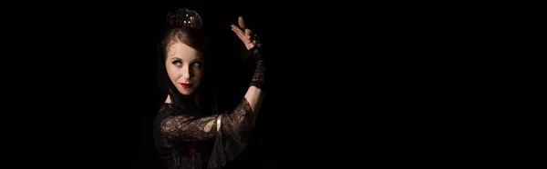 Panoramic crop of pretty young dancer dancing flamenco isolated on black — Stock Photo