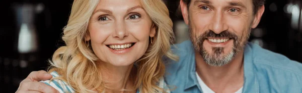 Horizontal cosecha de sonriente hombre abrazando hermosa esposa en casa - foto de stock