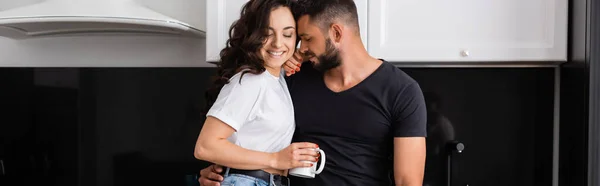 Panoramic shot of happy man near smiling girl holding cup of coffee — Stock Photo