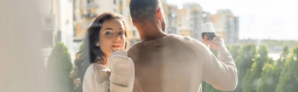 Horizontal image of man holding wine glass near attractive girlfriend outside — Stock Photo