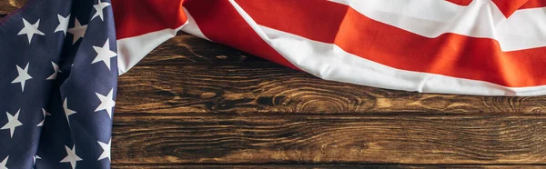 Horizontal image of american flag with stars and stripes on wooden surface — Stock Photo