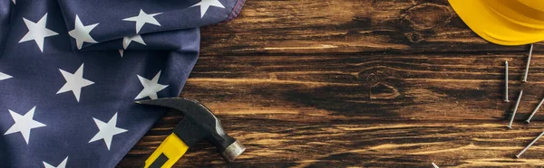 Panoramic shot of american flag and instruments near safety helmet on wooden surface, labor day cocnept — Stock Photo