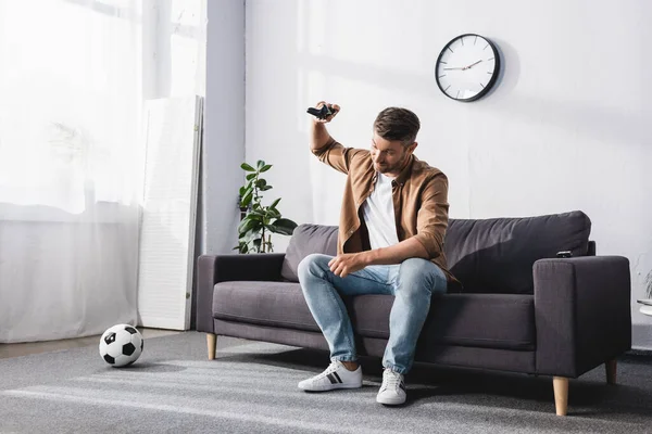 KYIV, UKRAINE - JUNE 9, 2020: angry man throwing joystick while losing video game — Stock Photo