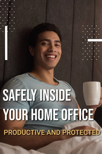 Улыбающийся смешанной расы человек держит чашку кофе почти безопасно внутри вашего домашнего офиса, продуктивные и защищенные надписи в спальне — стоковое фото