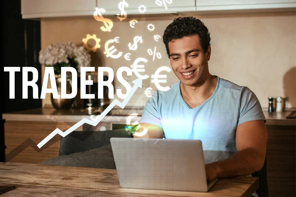 Cheerful mixed race freelancer using laptop near traders lettering and money signs — Stock Photo