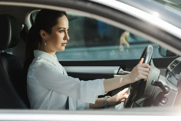 Side view of attractive businesswoman driving car — Stock Photo