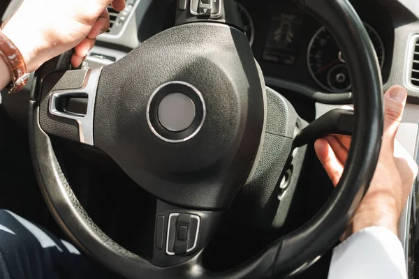 Cropped view of businessman driving auto at daylight — Stock Photo