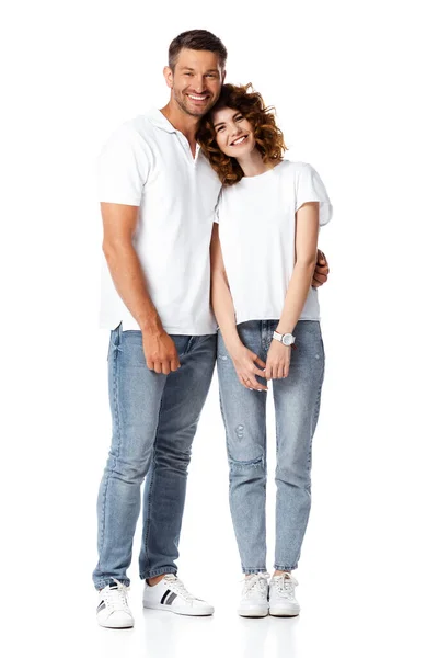Happy man smiling while hugging cheerful woman on white — Stock Photo