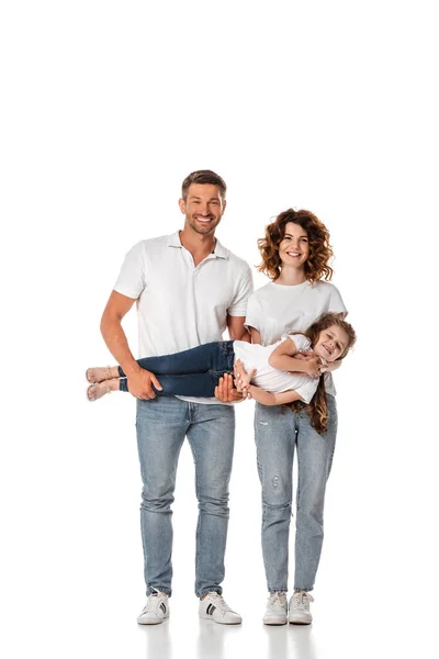 Feliz madre y padre celebración en brazos lindo niño en blanco - foto de stock