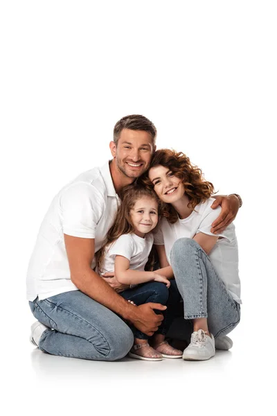 Homem feliz abraçando esposa e filha no branco — Fotografia de Stock
