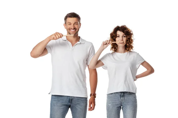 Cheerful couple brushing teeth isolated on white — Stock Photo