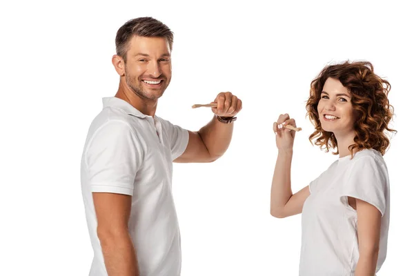 Happy couple holding toothbrushes isolated on white — Stock Photo