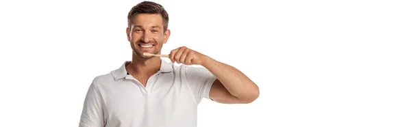 Panoramic orientation of cheerful man holding toothbrush while brushing teeth isolated on white — Stock Photo