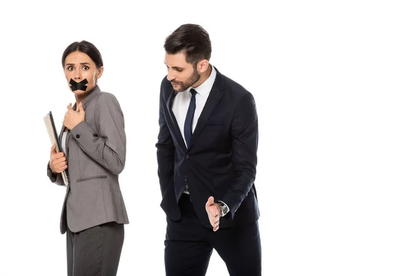 Businessman in formal wear molesting businesswoman with scotch tape on mouth isolated on white, sexual harassment concept — Stock Photo