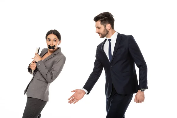 Bearded businessman in formal wear molesting businesswoman with scotch tape on mouth isolated on white, sexual harassment concept — Stock Photo