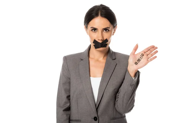 Attractive businesswoman with me too lettering on hand and duct tape on mouth isolated on white — Stock Photo