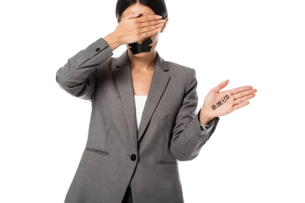 Businesswoman with me too lettering on hand and scotch tape on mouth covering eyes isolated on white — Stock Photo