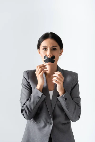 Businesswoman with scotch tape on mouth looking at camera isolated on white, gender inequality concept — Stock Photo