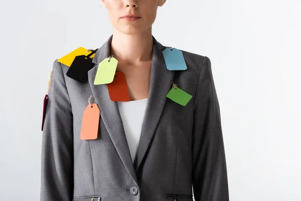 Cropped view of businesswoman with labels on suit standing isolated on white, gender inequality concept — Stock Photo