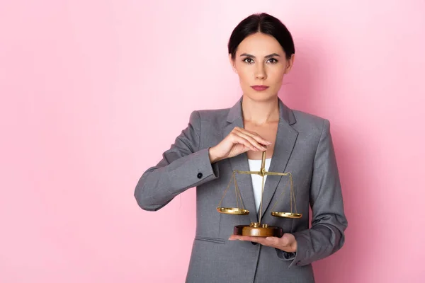 Attractive businesswoman holding scales on pink, gender equality concept — Stock Photo