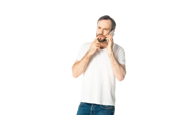 Pensive man talking on smartphone isolated on white — Stock Photo