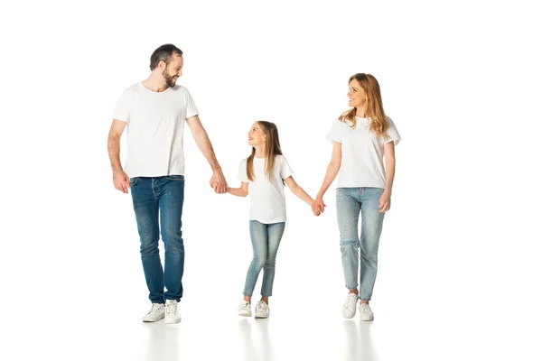 Happy casual family holding hands while walking isolated on white — Stock Photo