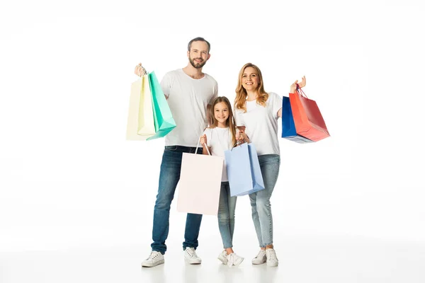 Cheerful family with colorful shopping bags isolated on white — Stock Photo