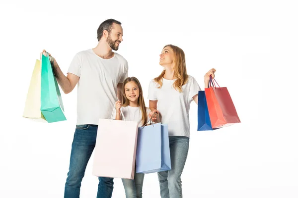 Cheerful family with colorful shopping bags isolated on white — Stock Photo