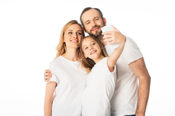 Happy family in white t-shirts taking selfie on smartphone isolated on white — Stock Photo