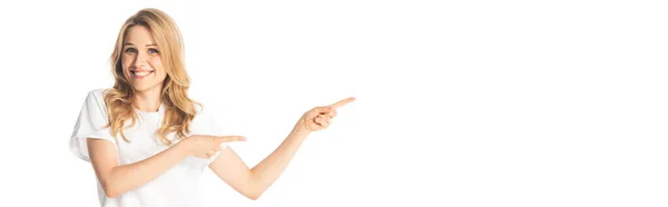 Smiling attractive adult woman pointing with fingers aside isolated on white, panoramic shot — Stock Photo